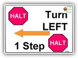 V21 HALT Turn Left 1 Step HALT 
 With the dog sitting at heel, the handler cues the dog to heel as she/he turns to the left (in place), while taking  one step in  that direction with either the right or left foot, “closing” with the other foot, then halts.  OR HALT turn left then take one step with the right or left foot and closing with the other foot. The dog moves with the handler while maintaining heel position. When the handler halts after taking the one step, the dog must sit. 
Deductions: Failure of the dog to sit at either halt will result in NQ-IP.
Failure of the dog to move with the handler during the turn will result in NQ-IP  
